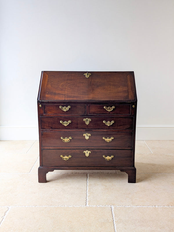 Antique George III solid mahogany bureau with a fall front, fitted interior and graduated drawers raised on bracket feet.