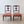 Load image into Gallery viewer, Antique Edwardian Sheraton Revival mahogany pair of salon chairs featuring anthemion marquetry, vase splats, red jacquard seats, and turned legs on brass castors.
