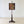 Load image into Gallery viewer, Antique William IV rosewood pole screen featuring a cushion-moulded frame enclosing a parrot needlepoint panel, set on a turned double-baluster stem and triform base.
