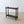 Load image into Gallery viewer, Antique Victorian mahogany stick stand featuring three upper compartments, turned finials, baluster uprights, an inset metal drip tray and turned feet.
