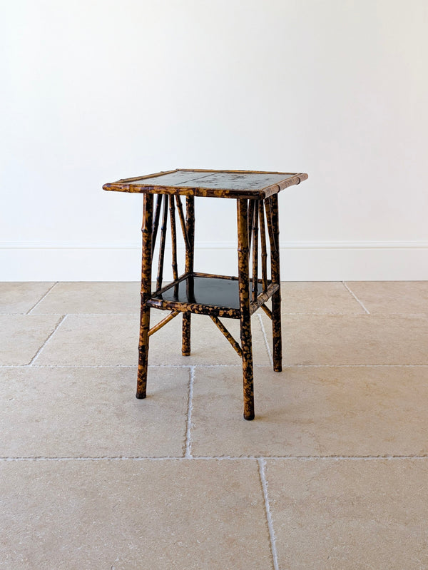 Antique Victorian bamboo occasional table of square form with a painted japanned top, lower tier, and gently splayed legs with decorative side braces.
