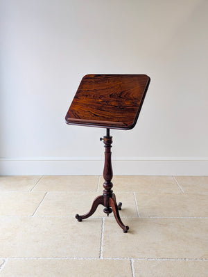 Antique William IV rosewood reading/music stand or occasional table with a rectangular tilt top, detachable book rest, brass quadrant mechanism, turned column, and tripod base.