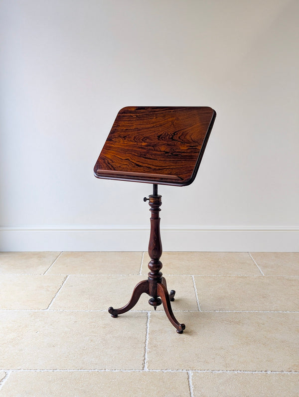 Antique William IV rosewood reading/music stand or occasional table with a rectangular tilt top, detachable book rest, brass quadrant mechanism, turned column, and tripod base.