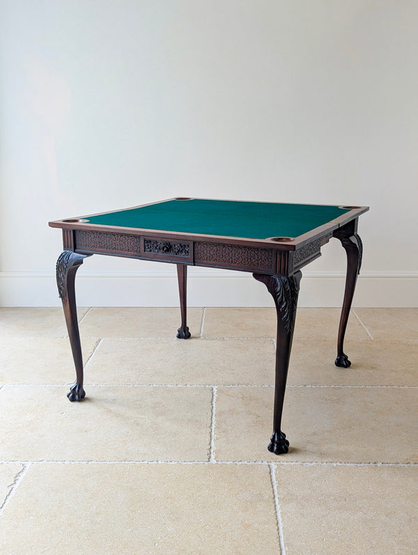 Antique Victorian Chippendale Revival mahogany card table by James Shoolbred with a carved blind fretwork frieze, acanthus cabriole legs, and ball-and-claw feet.