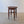Load image into Gallery viewer, Antique Edwardian Arts &amp; Crafts oak occasional table with a circular oxblood panel top, square-tapered flared legs, swept X-stretcher, and turned ball feet.
