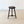 Load image into Gallery viewer, Antique late Victorian oak tripod stool featuring a carved sunflower top set over three splayed bobbin legs with a tripartite stretcher.
