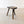 Load image into Gallery viewer, Antique Victorian elm and ash cutler's stool with a slab seat, canted corners, and wedged tenons, raised on three splayed ribbed legs.

