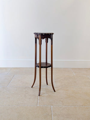 Antique Edwardian mahogany torchère featuring a lobed piecrust top, boxwood-strung frieze, pierced corner brackets, conforming undertier, and slender out-swept legs.