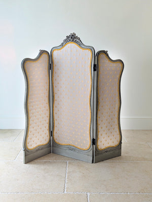 Antique Napoleon III painted three-fold room screen with deeply carved frames, gold bee motif silk upholstery, and original two-way hinges.