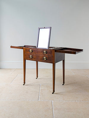 Antique George III mahogany gentleman's folding dressing table with hinged top leaves, fitted cosmetic interior, and square-tapered legs on brass cup castors.