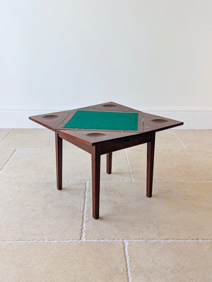 Antique Edwardian mahogany diminutive envelope card table with a swivelling top, green baize surface and a frieze drawer on four square legs.
