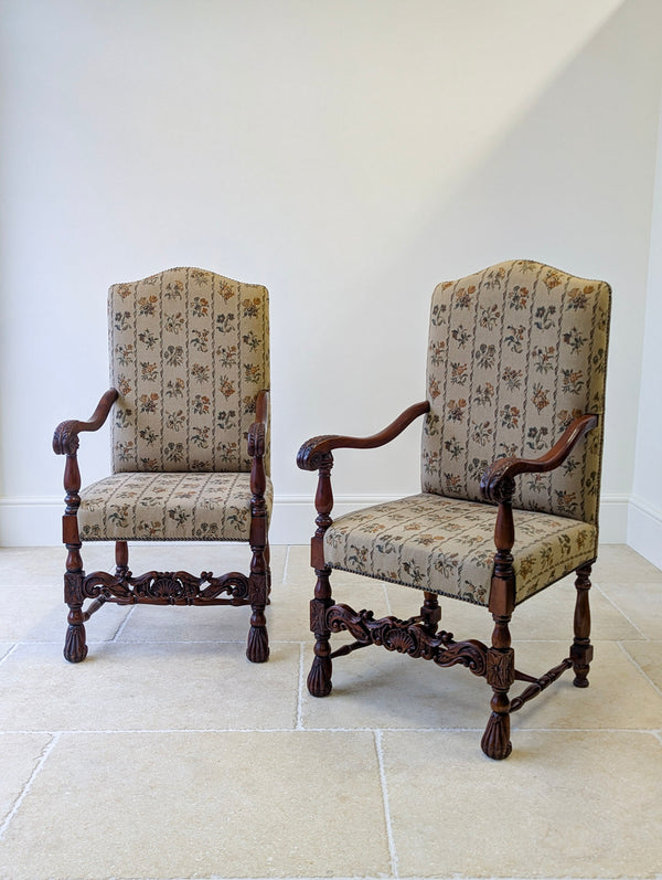Antique Late Victorian walnut William and Mary style open armchairs featuring floral-stripe tapestry upholstery, serpentine arms, and turned legs with carved feet.