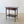 Load image into Gallery viewer, Antique late Victorian mahogany side table with applied geometric panel mouldings, corner spandrels, a serpentine lower undertier, and flared block feet.
