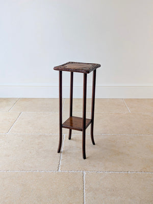 Antique Edwardian Arts and Crafts oak plant stand featuring a deeply carved square top, fixed undertier, and four slender square legs with splayed feet.