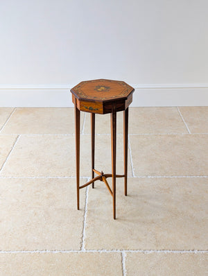 Antique Edwardian painted satinwood candle stand featuring an octagonal top decorated with a musical trophy medallion, raised on square-tapered legs with an X-form stretcher.