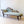Load image into Gallery viewer, Antique Victorian mahogany chaise longue with buttoned sage upholstery, open spindle gallery arm, and turned legs on brass and ceramic castors.
