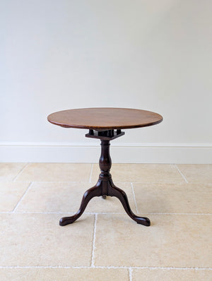 Antique Georgian mahogany tripod table with a single-piece circular tilt-and-rotate top on an original birdcage mechanism and cabriole legs.