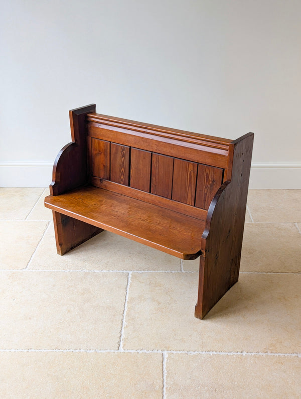 Antique Victorian Pitch Pine Pew featuring a panel back and single-plank seat with canted corners on chamfered solid slab standards.