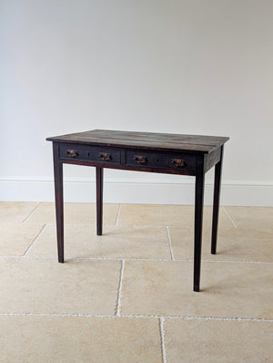 Antique Georgian oak side table featuring a heavily patinated three‑plank top and two frieze drawers with later neoclassical handles on tapered square legs.