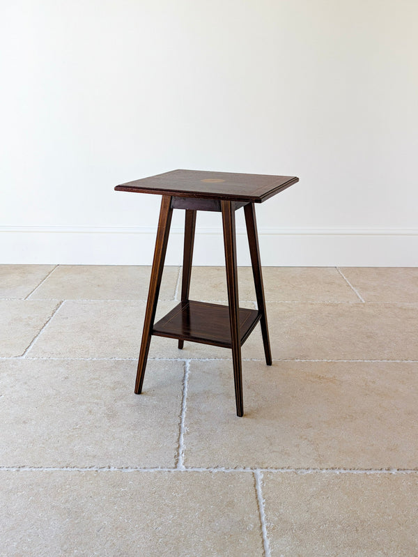 Antique Edwardian Sheraton Revival mahogany occasional table featuring a central boxwood fan patera, double line stringing, and splayed square tapered legs with an undertier.