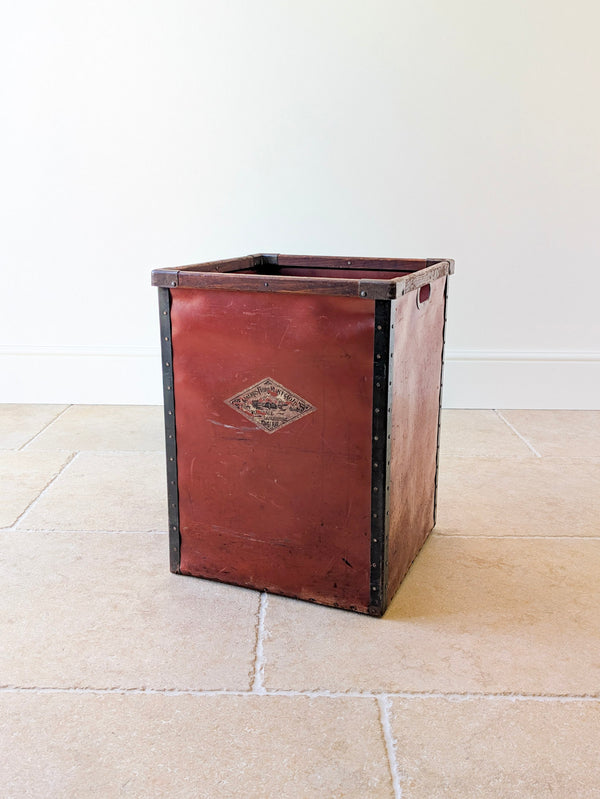 Antique Edwardian vulcanised fibre textile mill bin with solid hardwood rim, brass-lined handle, oxblood red panels, original decal, and riveted steel bindings.