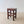 Load image into Gallery viewer, Antique Edwardian country pine stool with red paint finish, a hollowed rectangular top and square-section legs united by stretchers.
