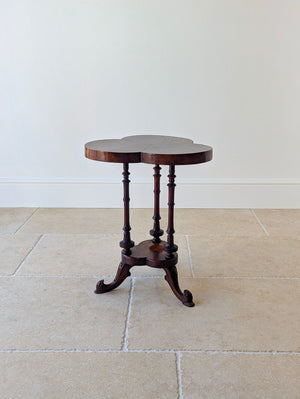 Antique Victorian burr walnut trefoil occasional table with a radially segment-cut top, turned solid supports, matching lower tier, and carved tripod legs.