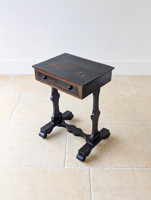 Antique Regency ebonised Chinoiserie work table with a hand-painted japanned top over a frieze drawer raised on flat trestle uprights.
