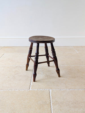 Antique Victorian country stool with circular elm seat and splayed ring-and-baluster turned beech legs.