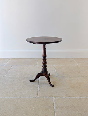 Antique George III solid mahogany tilt-top tripod table with a circular top, turned column stem, and cabriole legs with scroll feet.