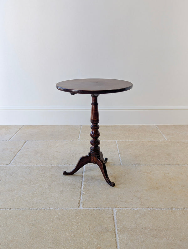 Antique George III solid mahogany tilt-top tripod table with a circular top, turned column stem, and cabriole legs with scroll feet.