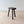Load image into Gallery viewer, Antique Victorian oak jeweller's stool with a thick single-piece rough-sawn slab seat with exposed wedged through-tenons, raised on three hand-faceted splayed legs.
