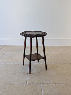 Antique Late Victorian Arts and Crafts walnut octagonal occasional table featuring a hand-carved ivy border, bead-moulded rim, splayed legs, and rosette undertier.